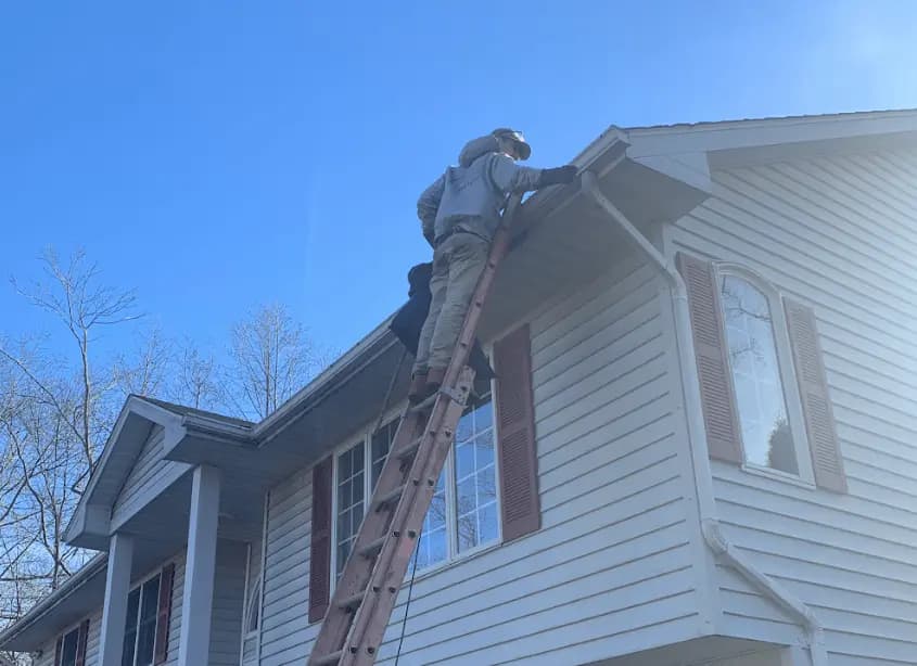 Gutter cleaning and maintenance being performed by Macedonia Power Washing in Macedonia